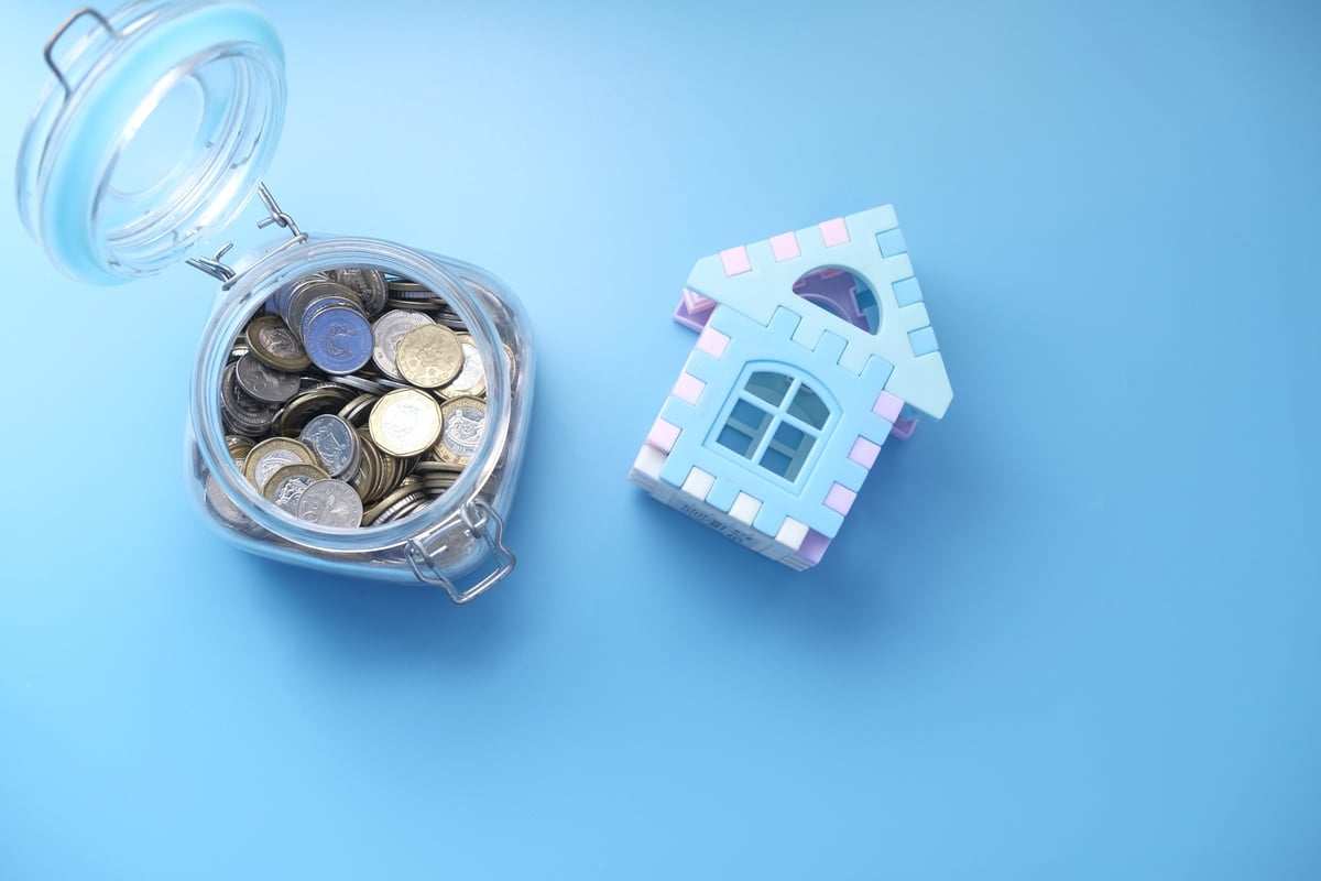 The Concept of Finance Concept with Stack of Coins and House on Table